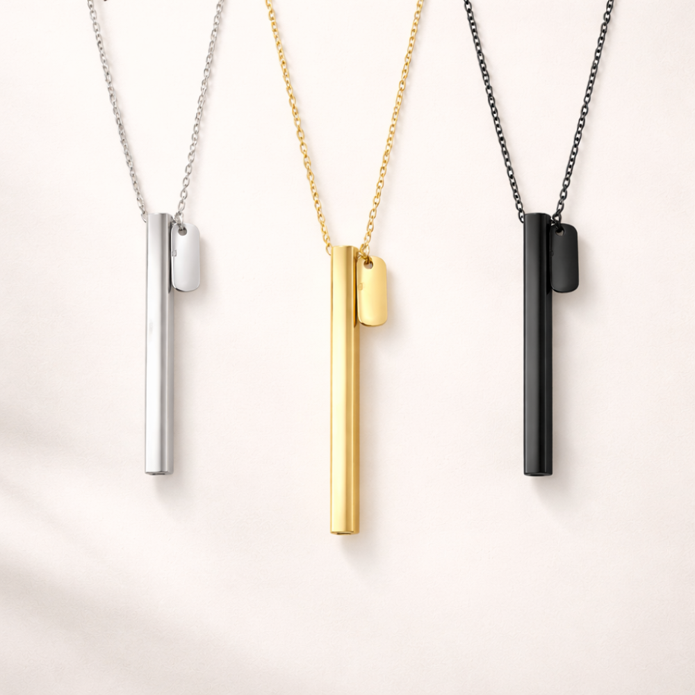 beprana breathing necklace in silver, gold and black finishes on neutral background