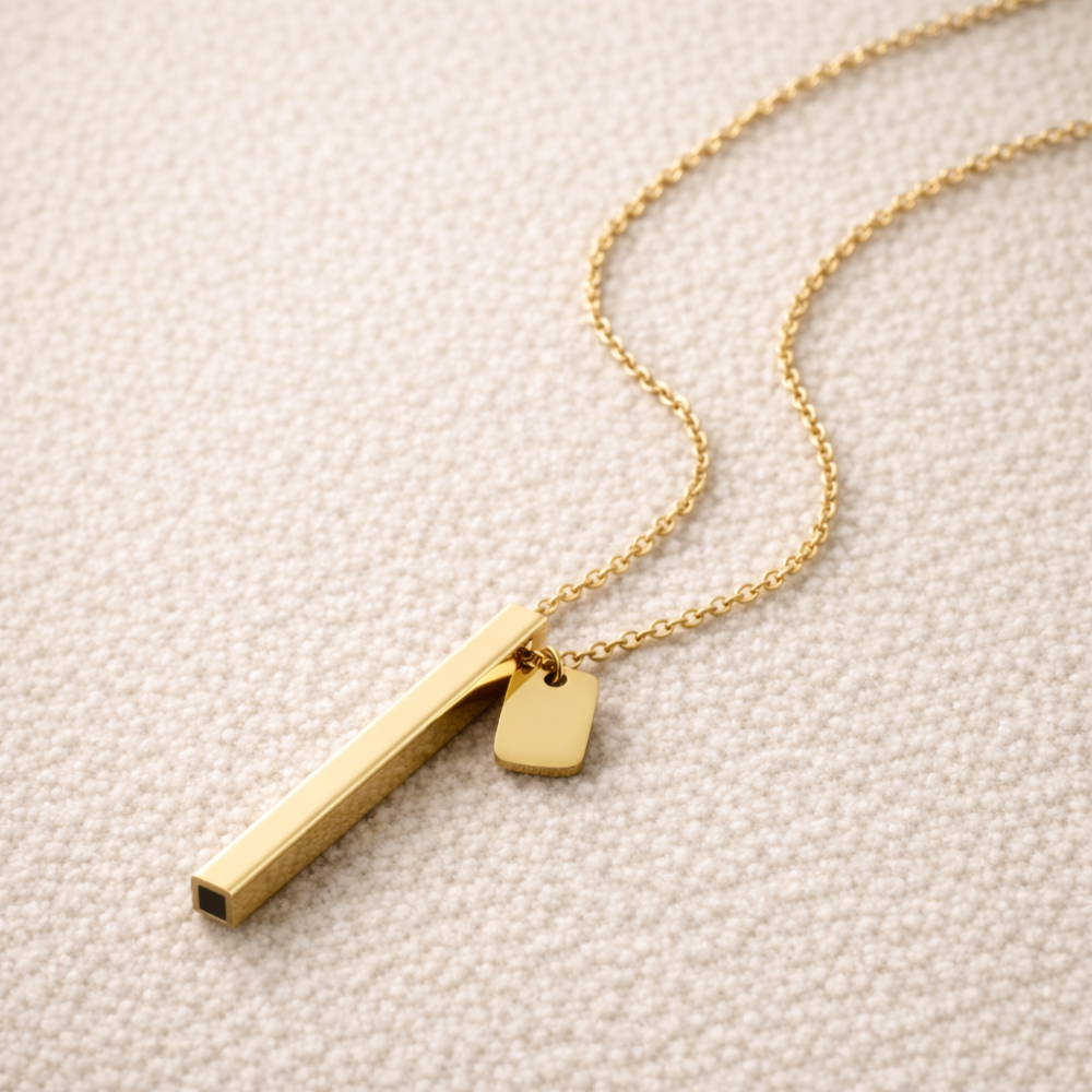 beprana gold breathing necklace with vertical bar pendant on neutral background