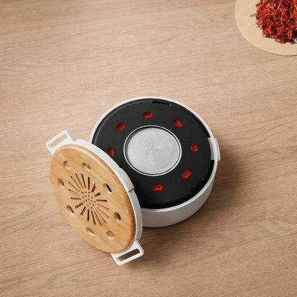 Portable heat therapy device opened, showing internal heating plate chamber on wooden table