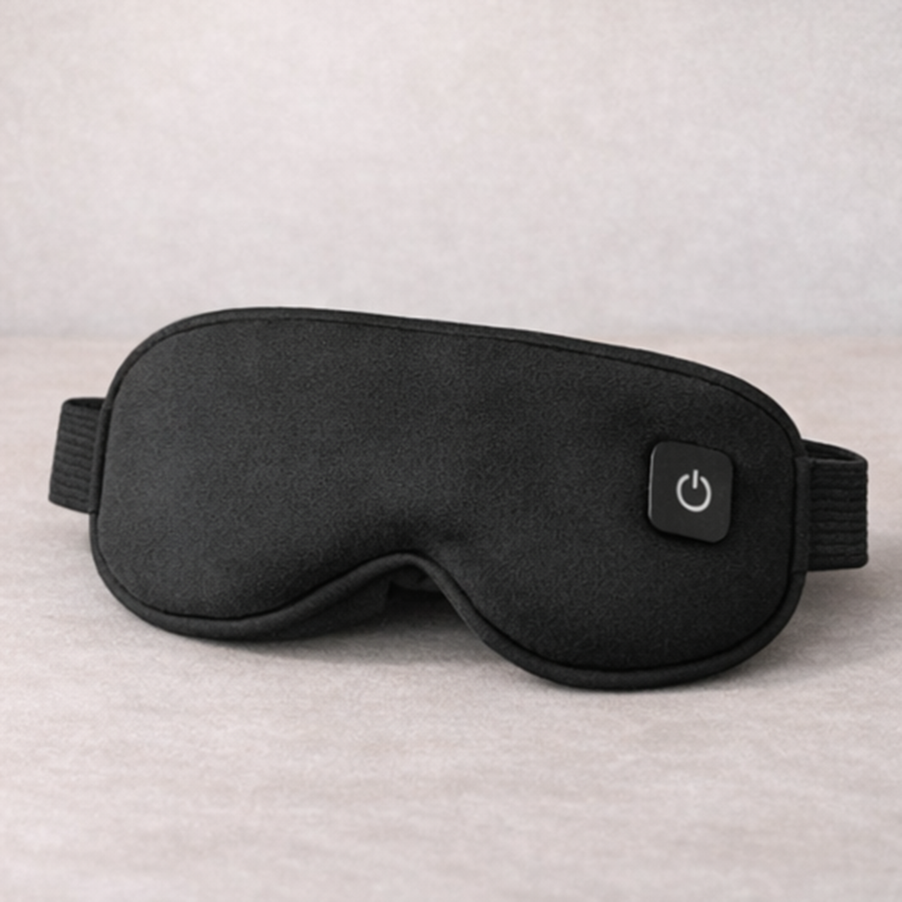 Black sleep mask with power button on a neutral background