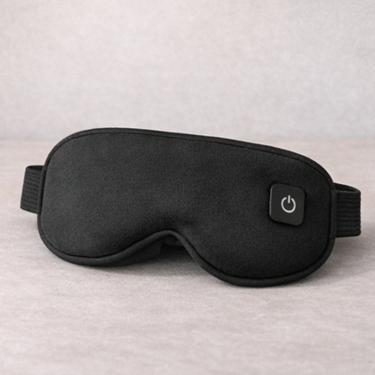 Black sleep mask with power button on a neutral background