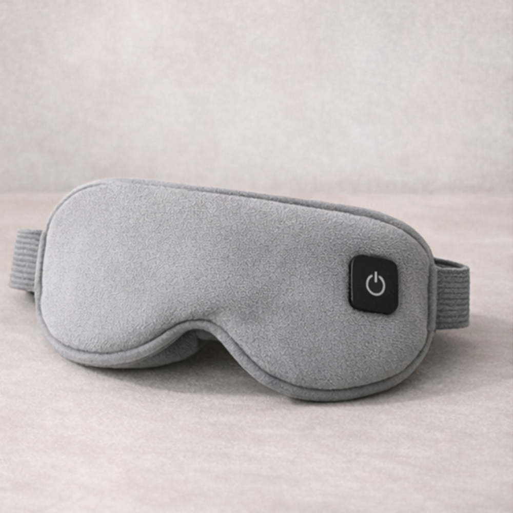 Gray sleep mask with power button on a neutral background