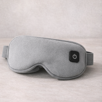 Gray sleep mask with power button on a neutral background