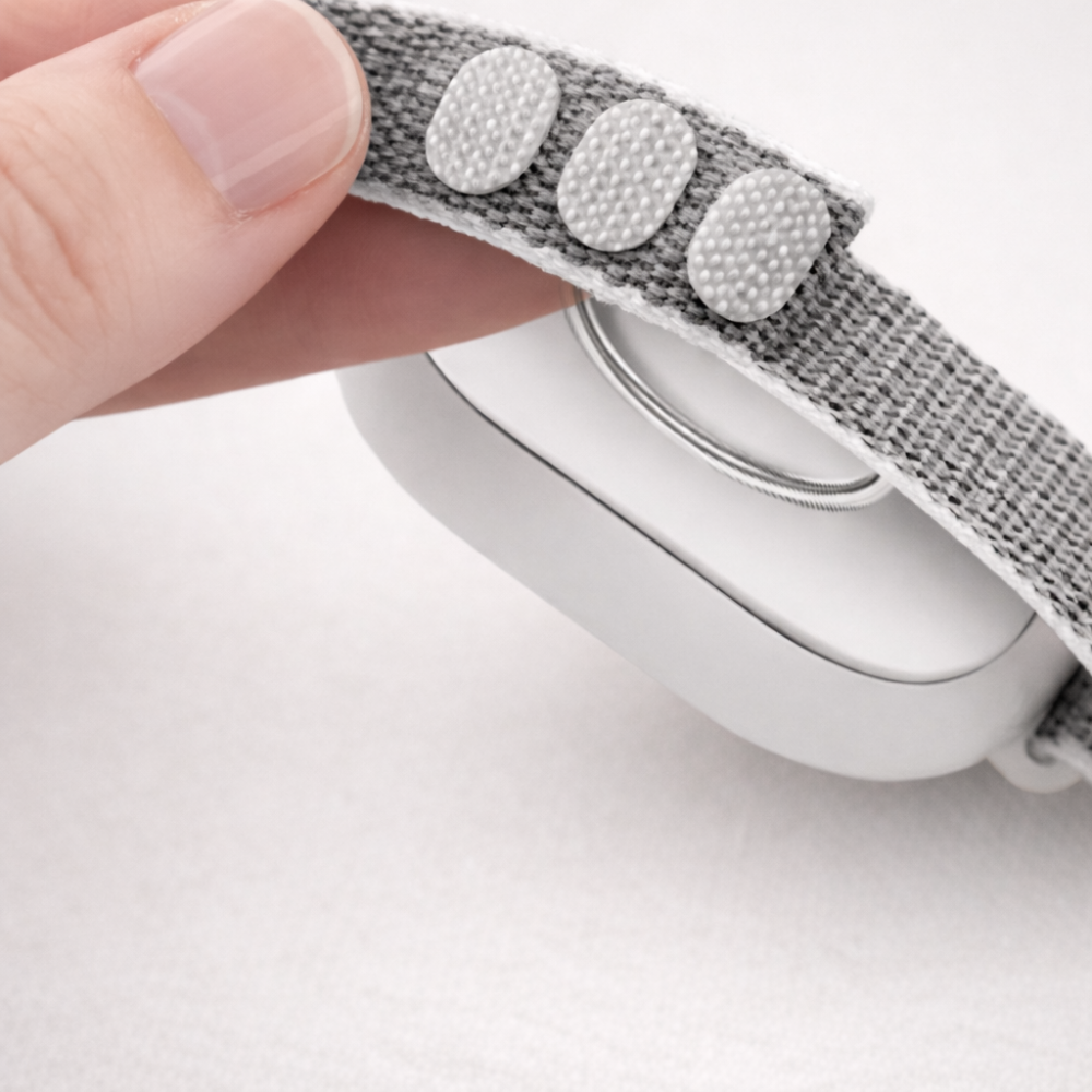 Hand demonstrating microcurrent device with adjustable strap 