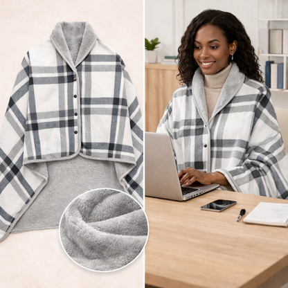 Woman working at a desk wearing a grey plaid wearable blanket wrap for warmth and focus